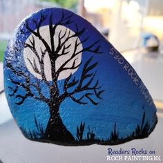 a painted rock with a tree on it