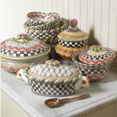 a table topped with lots of different types of covered dishes