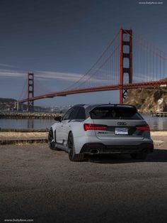 an audi car parked in front of the golden gate bridge