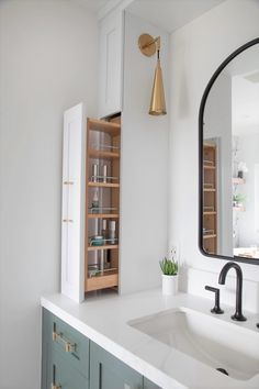 a bathroom with a sink, mirror and shelving unit