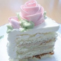 a piece of cake with white frosting and pink roses on top