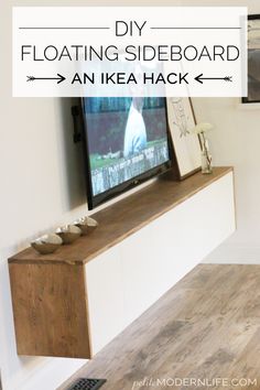 a flat screen tv sitting on top of a wooden entertainment center in a living room