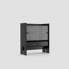 a black cabinet with glass doors on the top and bottom shelf, in front of a gray background