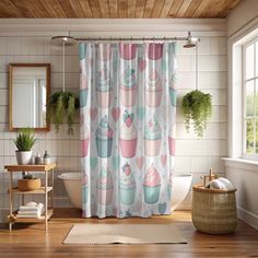 a bathroom with a shower curtain that has cupcakes on it and plants in the window