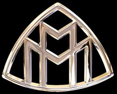 a gold brooch with the letter m in it's center, on a black background