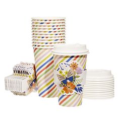 multicolored striped paper cups and plates on white background