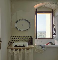 a white stove top oven sitting next to a window