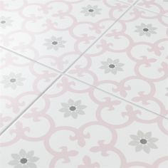 a tile floor with pink and grey flowers on it