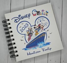 a spiral notebook with mickey mouse and friends on it