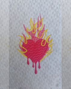 two pictures with different designs on them, one has a heart and the other has flames