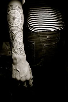 a person with tattoos on their arms and arm