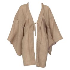 Sometimes called iro muji, short kimonos can act as lingerie cover-ups as well as lightweight blouses or jackets. In a versatile putty color, this unusual version features rich texture and a single tie closure that creates an alluring plunging neckline when worn with nothing underneath. Tonal silk jacquard short kimono with plunging neckline, folded shawl collar and drop-shoulder kimono sleeves; tie closure at sternum. Fully hand-finished with French seams; unlined. fabric: tonal silk/rayon jacq Half Kimono, 1960s Lingerie, Haori Jacket, Silk Cardigan, Kimono Sleeves, Short Kimono, French Seam, Kimono Sleeve, Kimonos