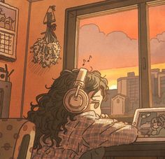 a person sitting at a desk with headphones on and looking out the window while listening to music