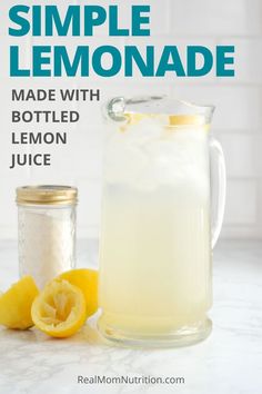 a glass pitcher filled with lemonade next to a jar and sliced lemons on the counter