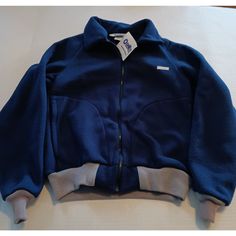 Add A Classic Touch To Your Little Boy's Wardrobe With This Oshkosh B'gosh Bomber Jacket In Vintage Blue And Gray. This Mid-Length Jacket Is Made In The Usa With A Blend Of Polyester And Other Fabrics. It Features A Full Zip Closure, Long Sleeves, And Pockets To Keep The Hands Warm. Perfect For Casual Outings, Parties, And Travel, This Jacket Comes In Size 16 And Fits Regular. It Has A Solid Pattern And A Usa Theme That Complements Its Vintage Style. This Jacket Is Machine Washable For Easy Care Blue Insulated Outerwear For Cold Weather, Blue Insulated Hooded Outerwear, Insulated Blue Outerwear For Outdoor Activities, Blue Insulated Outerwear For Hiking, Insulated Blue Outerwear For Hiking, Blue Fleece Jacket For Hiking In Fall, Blue Winter Hiking Fleece Jacket, Kids Jacket, Size 16