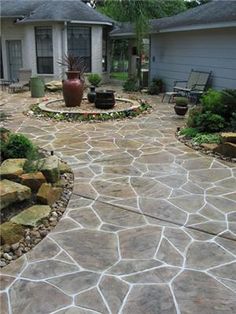 an outdoor patio with flagstone pavers and stone steps