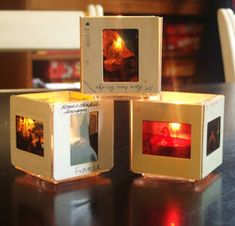 three cubes with pictures on them sitting on a table in front of a fireplace