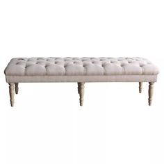 an upholstered bench with wooden legs