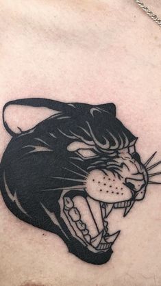 a close up of a person's chest with a tiger tattoo on the chest