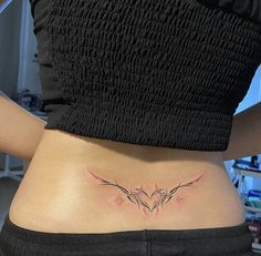 a woman's lower back tattoo with two birds on it