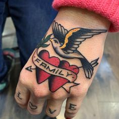 a woman's hand with a tattoo on it that says family and a heart