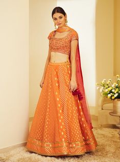 Editor's Note This set features a zardozi embroidered orange brocade lehenga with blouse and dupatta. Color: Orange Fabric: Silk Jaquard And Chanderi Jaquard Embroidery Details: Zardoq Care: Dry Clean Only Customize Your Outfit Can't find the size you're looking for? No stress. Just select the size "Custom" while adding the item to your cart. We will follow up with you for your body measurements. To request a color or design customizations, please contact our customer care by using our "Ask us a Lehenga With Blouse, Brocade Lehenga, Embroidered Orange, Blouse Yoke, Embroidered Lehenga, Casual Tunics, Orange Fabric, Indian Ethnic Wear, Fabric Silk