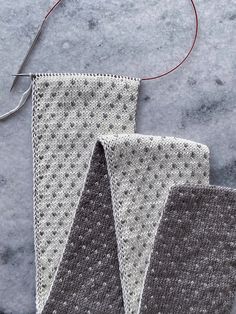 two pieces of knitted fabric sitting next to each other