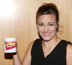 a woman holding up a mug with the words hotdogs written on it