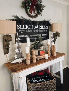 a mantle with candles and christmas decorations on it