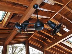 the ceiling is made of wood and has three lights on it