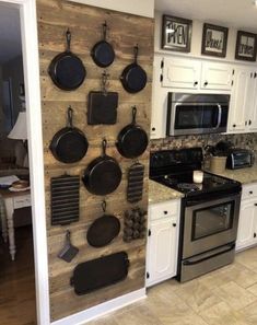 a kitchen with an oven, stove and pans on the wall in front of it