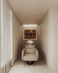 a white chair sitting in the middle of a room next to a wall with shelves on it