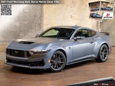 a silver car is parked in front of a brick wall and has an advertisement for the new ford mustang