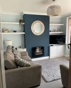 a living room filled with furniture and a fire place