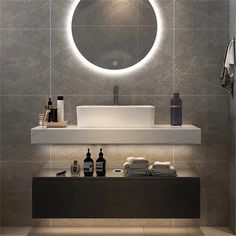 a bathroom with a sink, mirror and soap dispenser on the counter