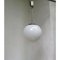 a white light hanging from a ceiling in a room