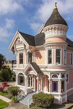 a pink victorian style house on a sunny day