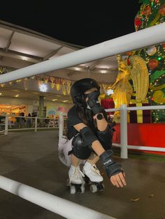 a woman in black and white is on roller skates near a decorated christmas tree