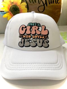 Thank you for visiting my shop! Perfect Summer Trucker Hat to Keep the Sun out of your face. Show your Faith wherever you go, with this trendy "Just a Girl Who Loves Jesus" hat.  This hat is perfect for those ladies who know they can rest in Jesus. Printed in crisp colorful letters on a white background, making it stand out.  Perfect for beach days, concerts, or everyday wear. This cap is a must-have for any Christian fashionista.  Details: These hats are durable through wear and tear.  Material: 100% Polyester, foam front with 100% nylon mesh weave back.  One size fit most  Adjustable Snap Back Trucker Hat. Please note:  Creases on the hat will straighten out naturally once unpackaged and worn. White Trucker Hat With Letter Print, White Trucker Hat With Letter Print And Flat Brim, Fun White Snapback Hat With Letter Print, Cute White Hat With Letter Print, Cute White Hats With Letter Print, Cute White Baseball Cap With Letter Print, White Hat With Letter Print, One Size, Customizable White Dad Hat, One Size Fits Most, Customizable White Dad Hat One Size Fits Most