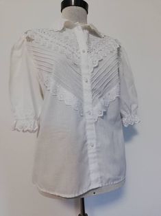 Beautiful vintage  blouse white colour, romantic style. It has buttons in front for closure and puff embroidered sleeves. The  amount of embroidery makes it a gorgeous piece.  It is a reasonable good vintage condition.  In the last pic you ll see a line which is unsewd but it is easy to fix.  It is a modern M.  Measurements : Shoulders 42 cm Bust 118/120 Waist 118/120 Length of the sleeve 36cm Size on label   is  missing. Cotton Lace Blouse, Shirt Collar Blouse, Victorian Blouse, White Victorian, Dirndl Blouse, Oktoberfest Outfit, Dirndl Dress, Folk Dresses, Collar Blouse