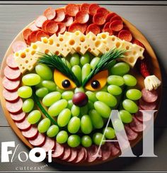 a platter with grapes, meats and cheese as the face of an animal