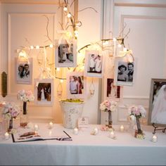 a white table topped with pictures and flowers