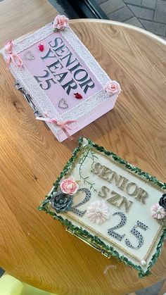 a cake sitting on top of a wooden table next to a sign that says senior year