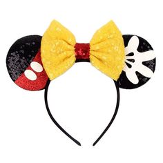 a mickey mouse ears headband with a yellow bow