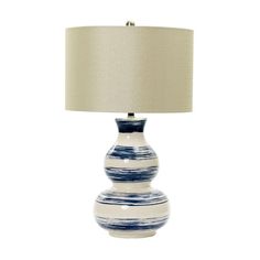 a blue and white lamp with a beige shade