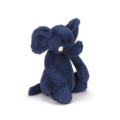 a small blue stuffed elephant sitting on the ground