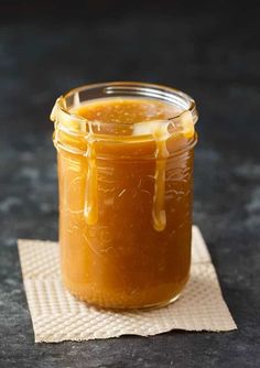 a glass jar filled with liquid sitting on top of a napkin