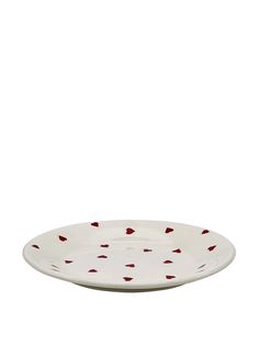 a white and red plate with hearts on the rim, sitting against a white background