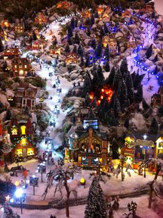 a christmas village is shown with lights and trees