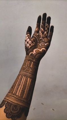 a woman's hand with henna on it